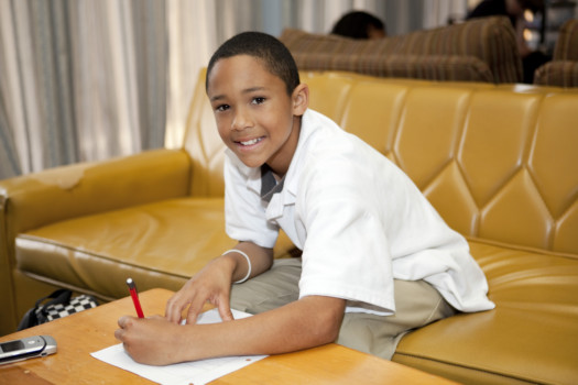 print a poster - Boy Sitting On Couch Writing On Paper - 001bgc.jpg